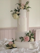4 tier elegant wedding cake with sparkle fresh flowers